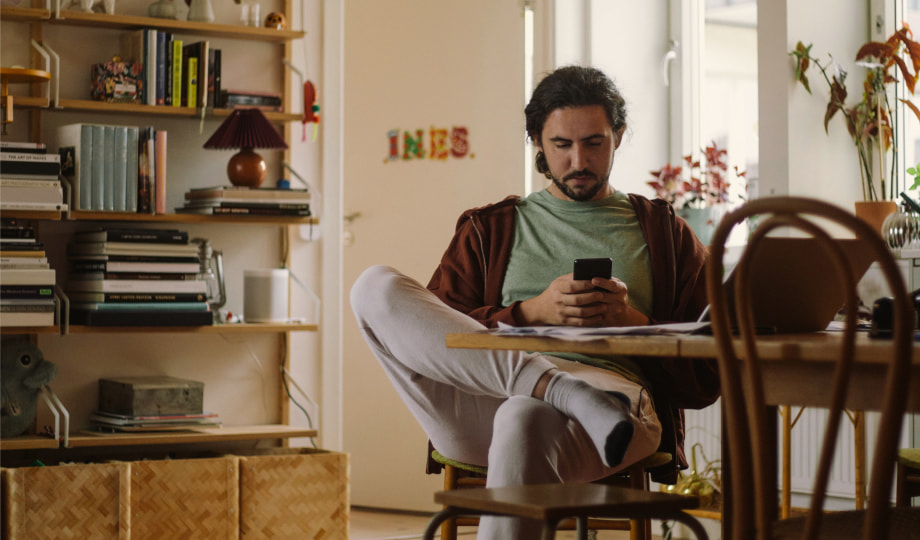 Man on his phone working at a table